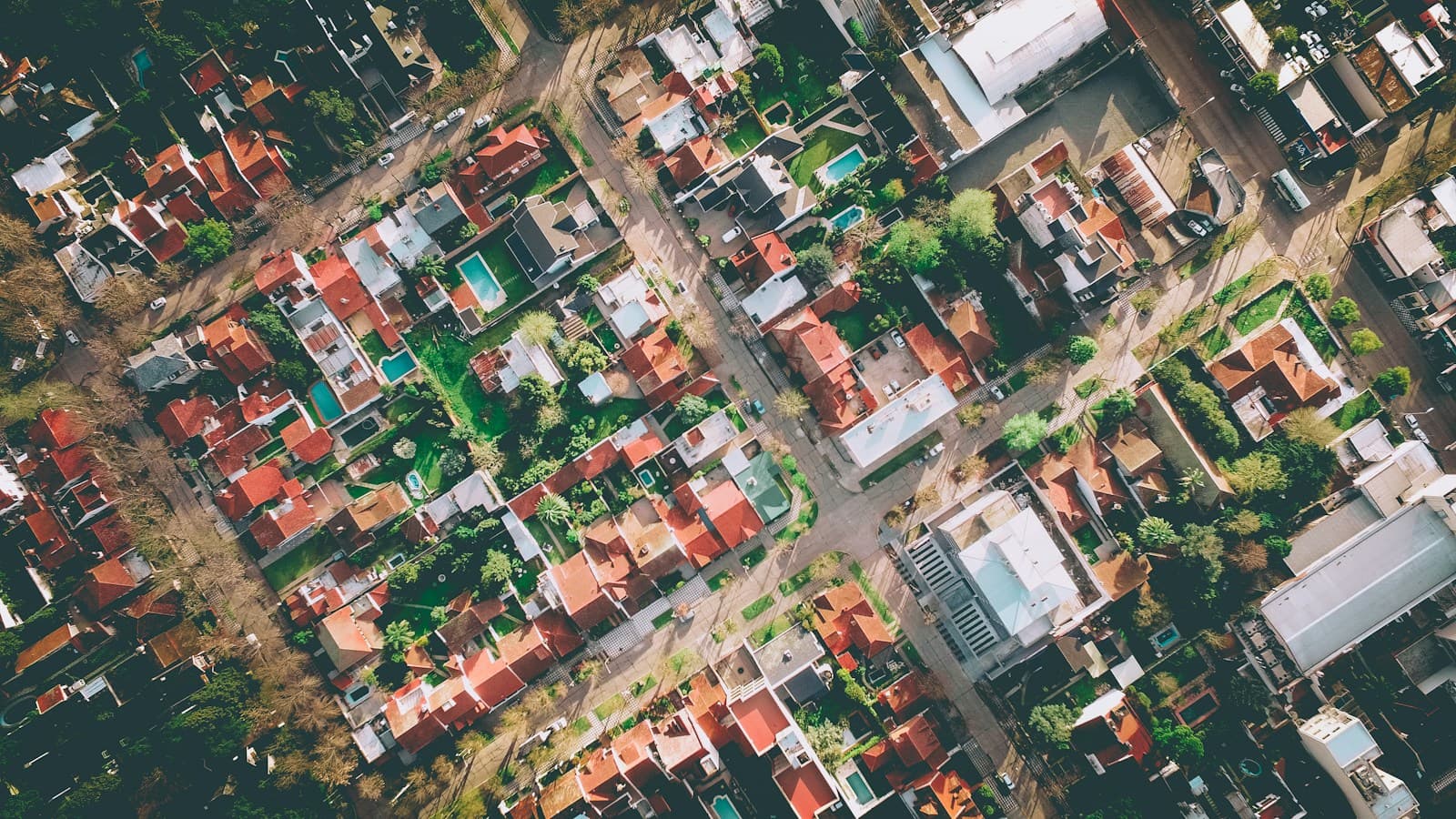 Overhead photograph of a neighbourhood, its buildings, streets and tree cover